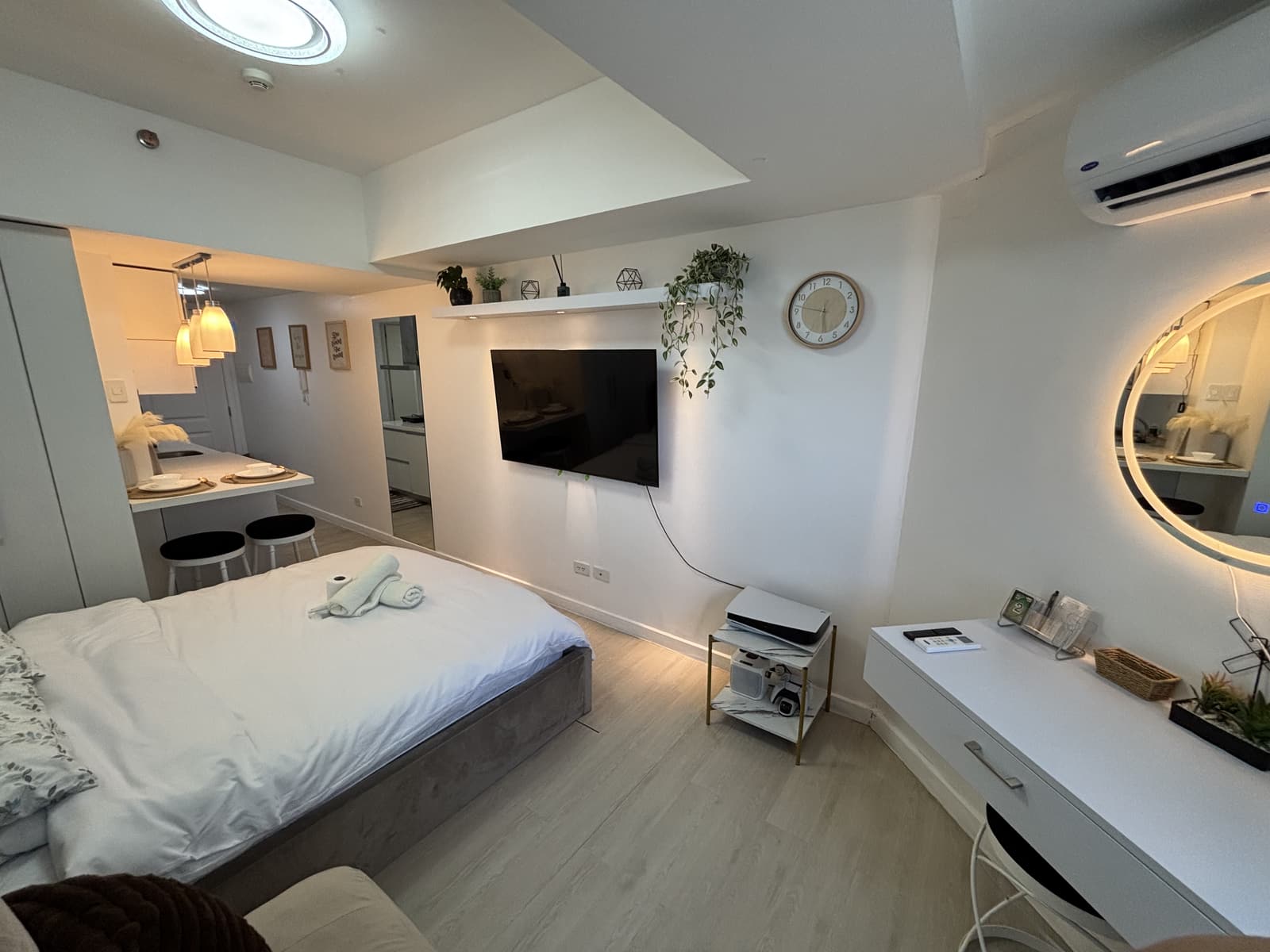 Spacious studio layout with bed, lounge, kitchenette, and Smart TV