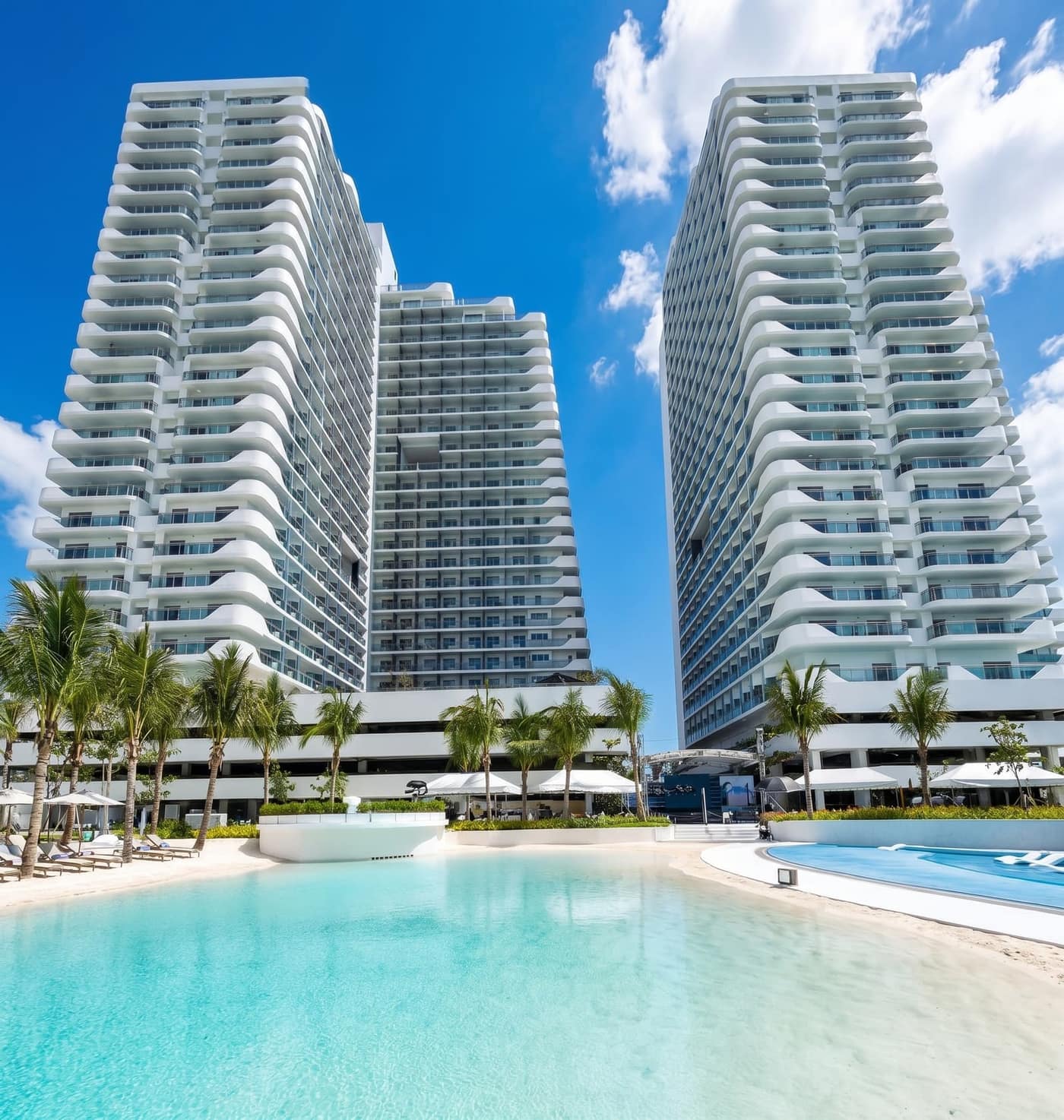 Twin Azure North towers framing the wave pool and palm-lined beach